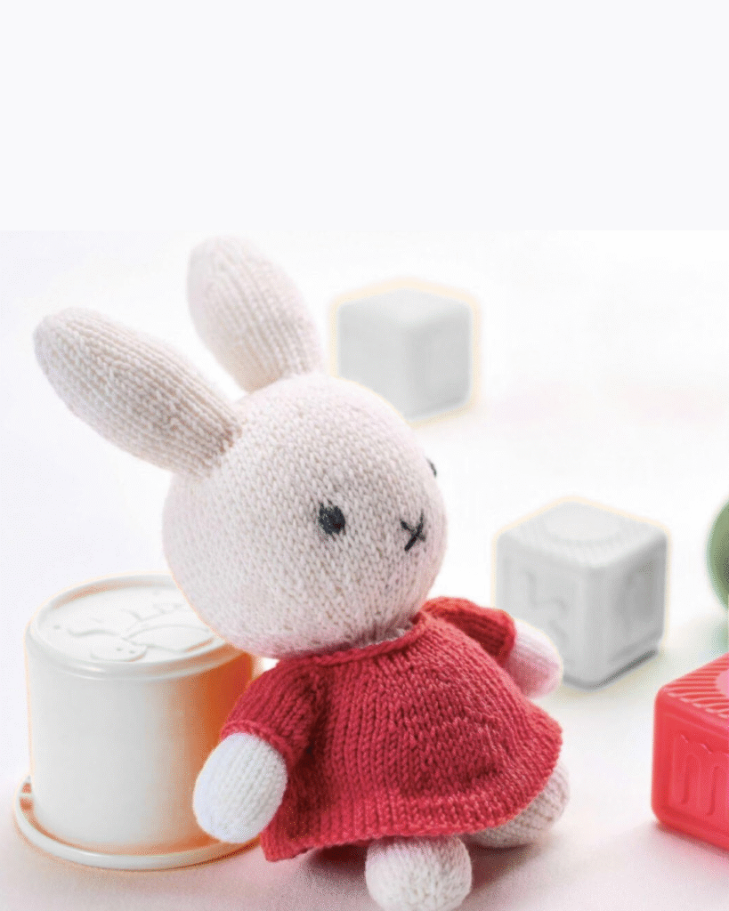 knitted Miffy toy, miffy the rabbit wearing a red dress, knitting pattern by jane burns