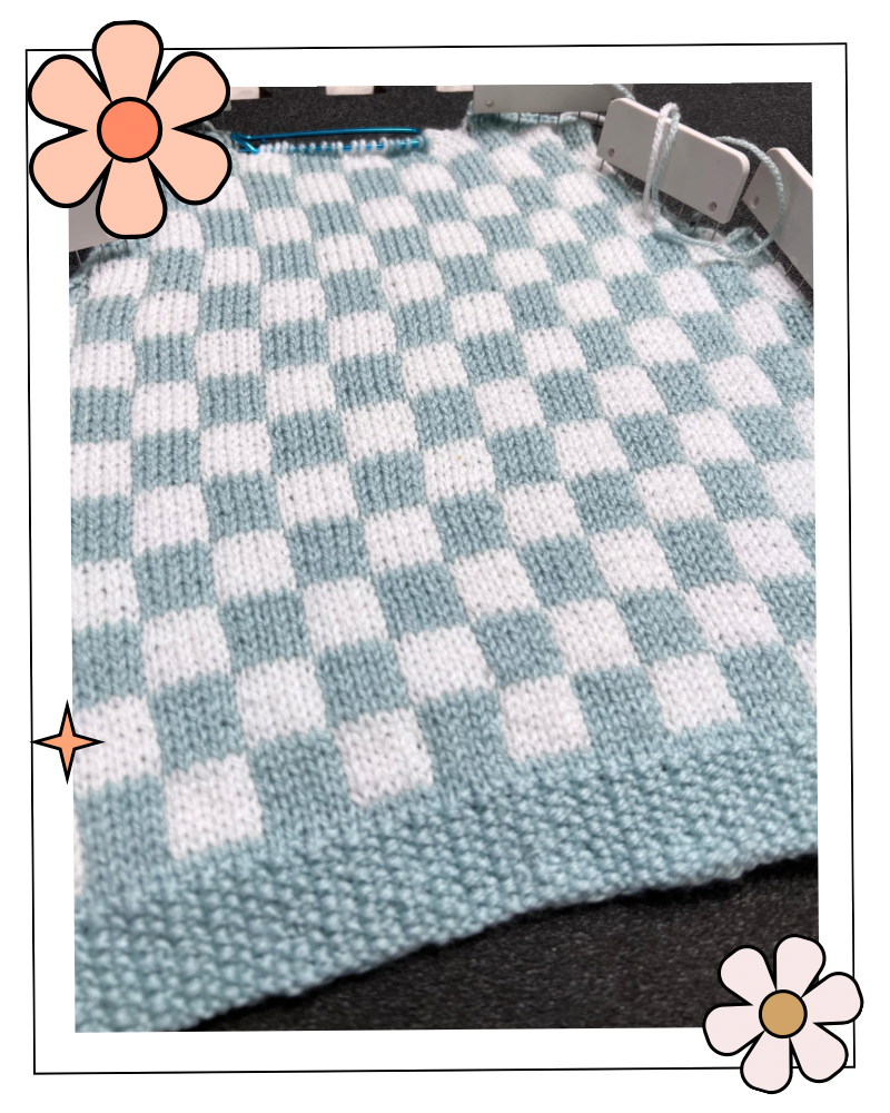 stranded knitting colourwork fabric in white and blue squares showing the fabric pinned out reading for blocking