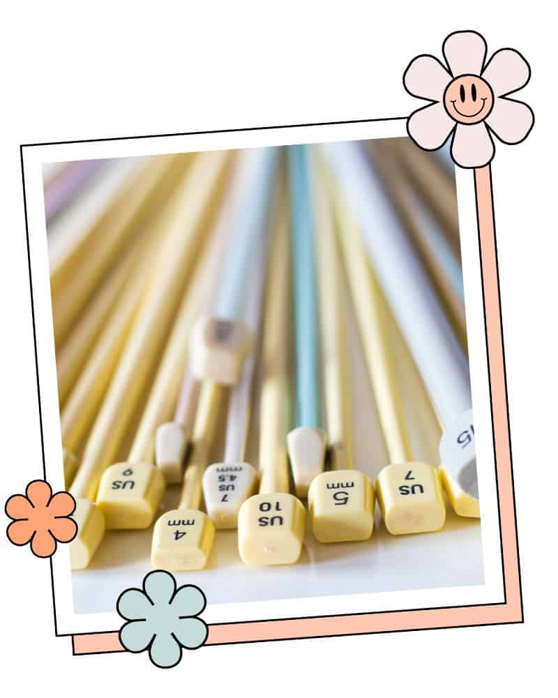 a selection of knitting needles showing different needle materials and sizing systems including old UK, metric and US needle sizes jane burns knitting needle sizing conversion chart