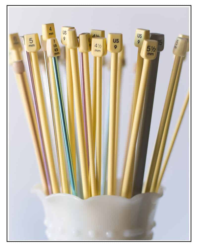 a selection of knitting needles showing different needle materials and sizing systems including old UK, metric and US needle sizes jane burns knitting needle sizing conversion chart