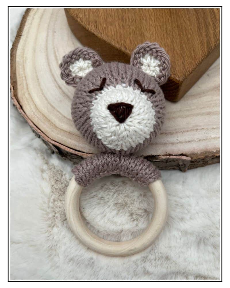 Knitted teddy bear rattle with wooden teething ring, King Cole cotton yarn free pattern