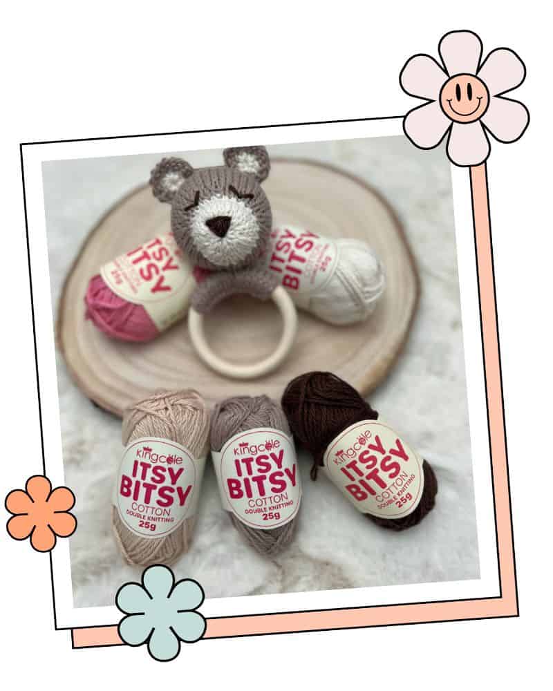 Close up of knitted teddy bear head and ears, baby rattle pattern detail