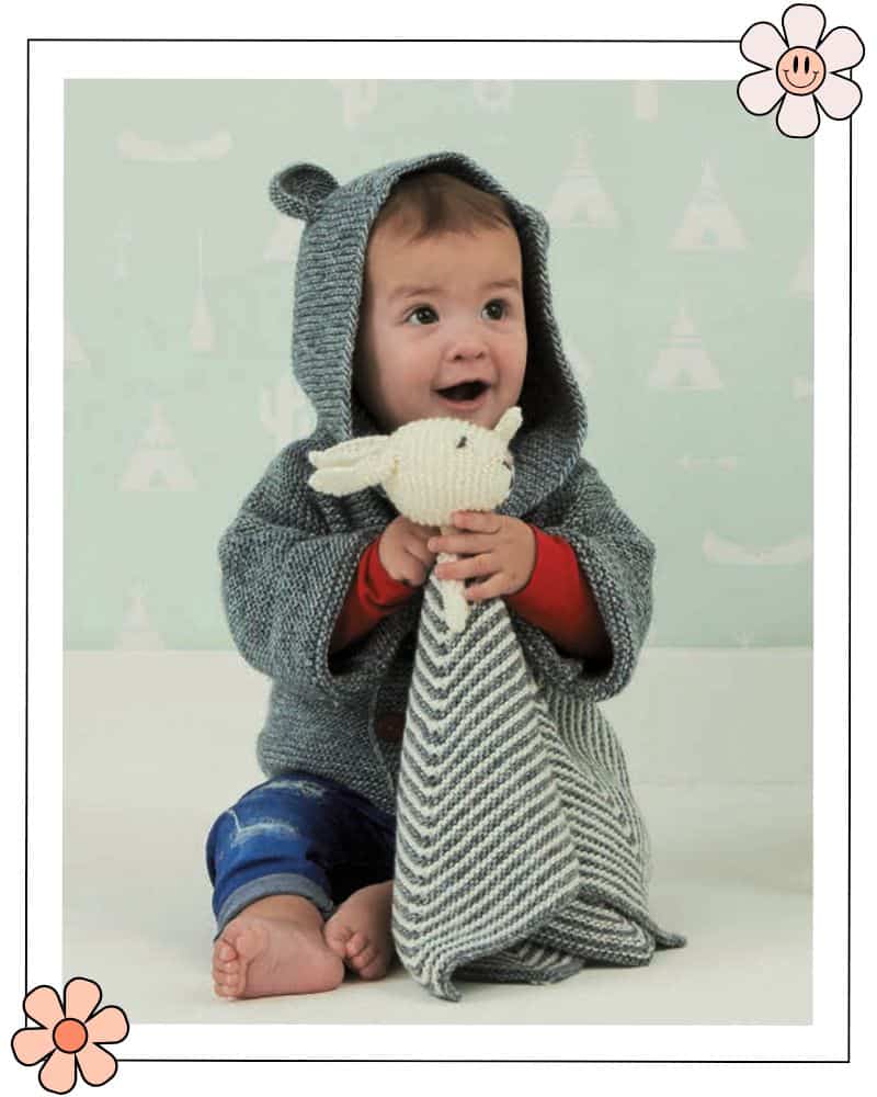 baby bunny blanket knitting pattern for scheepjes designed by jane burns small child cuddling a knitted rabbit attached to a knitted blanket