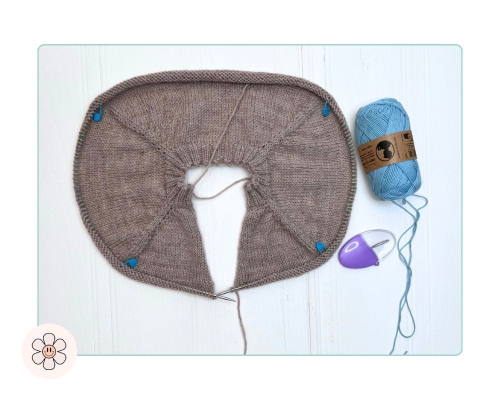 Image shows, length of scrap yarn ready to hold sleeve stitches during the separation row of a top-down cardigan how-to-knit-a-top-down-cardigan-for-kids
