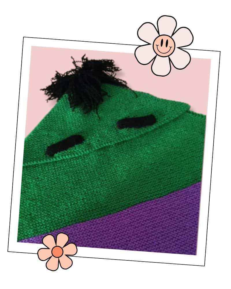 Frankenstein Monster Baby Blanket Knitting Pattern: Free 3 Close-up of green garter stitch Frankenstein monster baby blanket with knitted black eyebrows, Jane Burns knitting pattern - frankenstein monster baby blanket knitting pattern