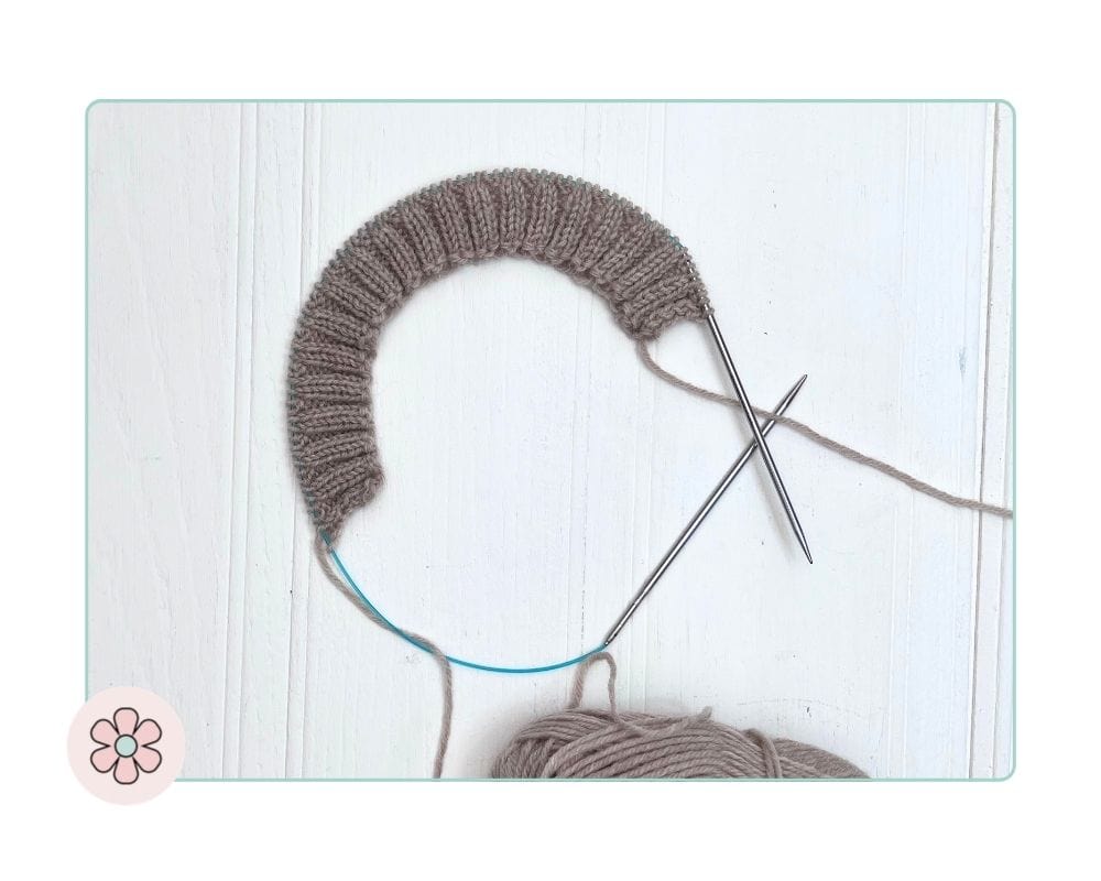 K2P2 collar ribbing in progress on a children's top-down cardigan, worked flat on circular needles