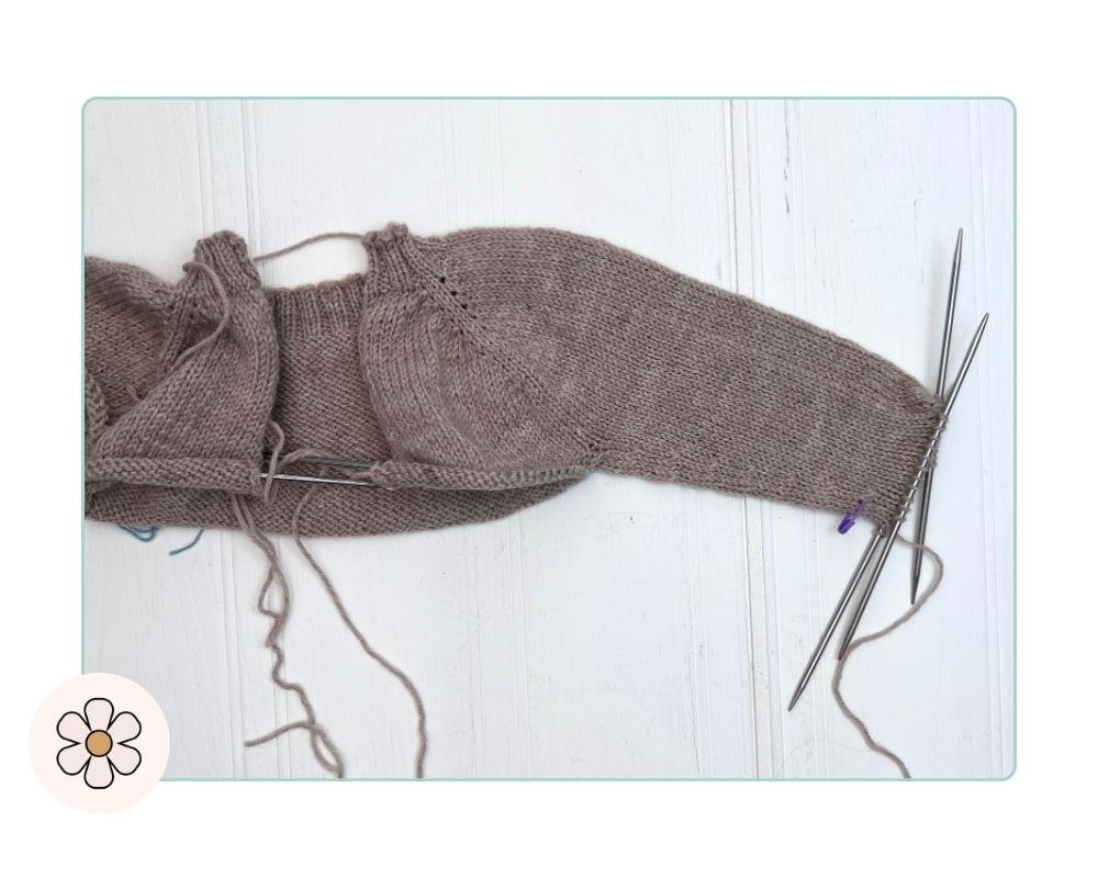 Image shows, sleeve decreases complete on a top-down children's cardigan, cuff stitches on needle ready for ribbing how to knit a top down cardigan for kids
